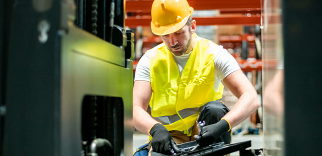 3stock photo mechanic repairing forklift in warehouse 1868987752 1